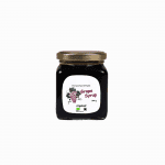 Organic grape syrup in a glass jar, highlighting high-quality products for a natural health and wellness lifestyle.